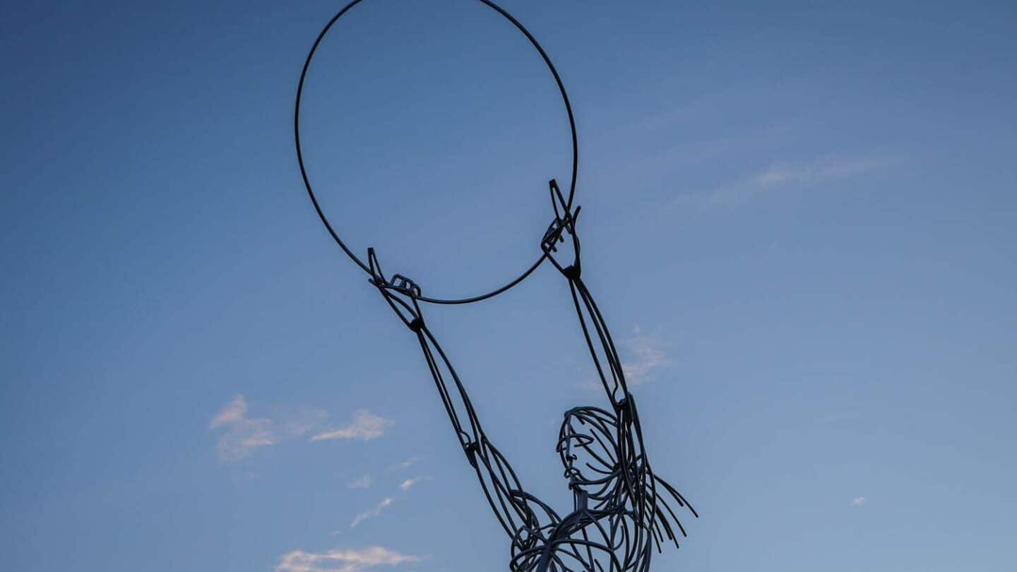 Beacon Of Hope, Belfast. Metal sculpture of female figure holding aloft a circle. Courtesy of Tourism NI