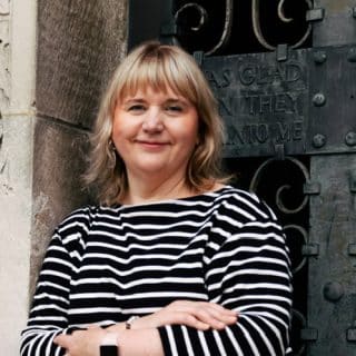 Susan Picken, BIAF's general manager - a white woman with blonde hair, wearing a black and white striped jumper.