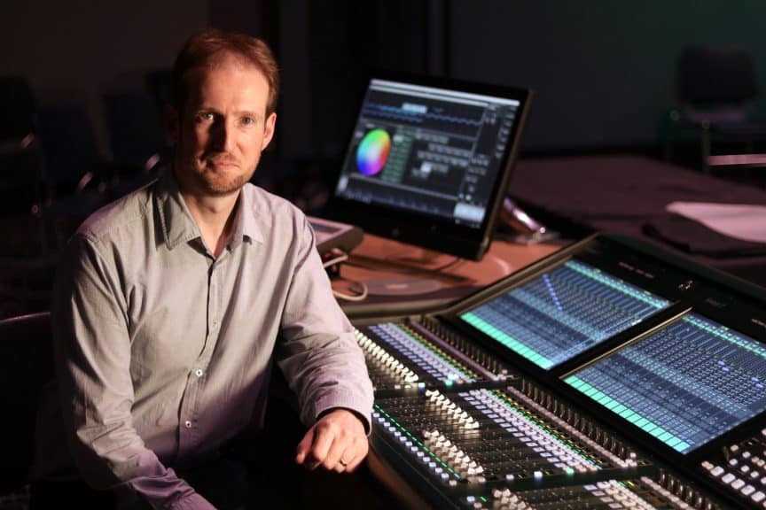 Chris Corrigan seated at a sound desk.