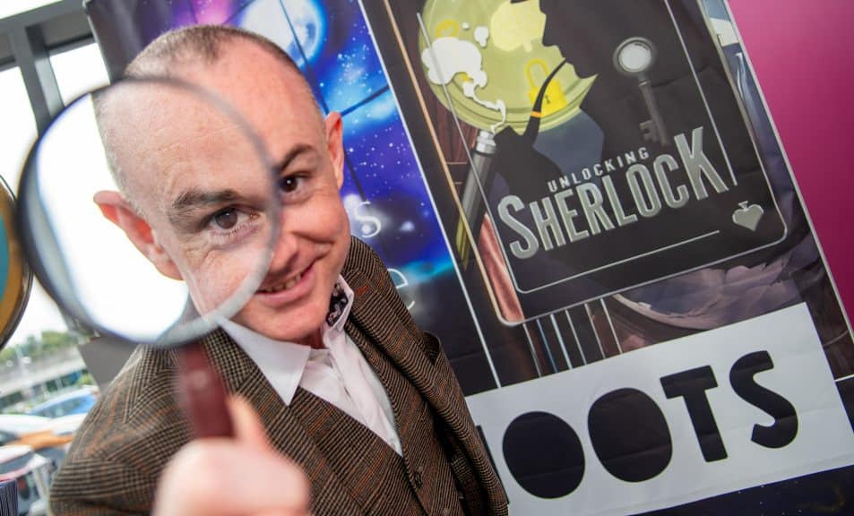 Caolan McBride holding a magnifying glass.