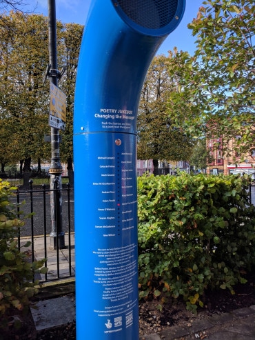 Poetry Jukebox outside Crescent Arts Centre. It is a long blue funnel, with a panel of metal buttons, which the user presses to hear a poem of their choosing. Photographer Simon Hutchinson